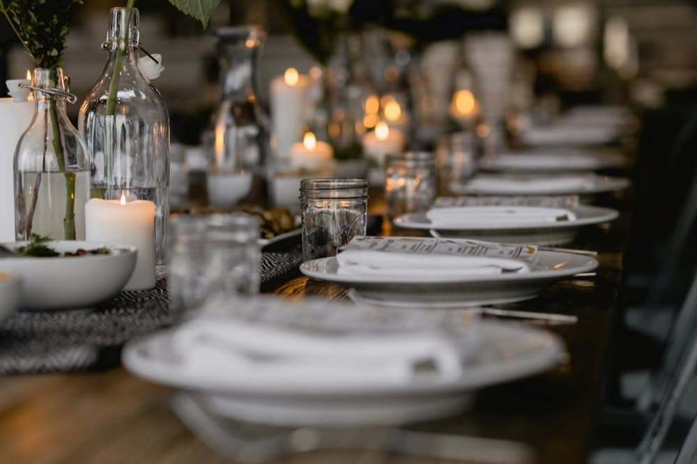 A birthday party at a long table, candles lit